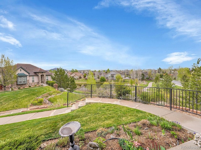 view of yard featuring fence and a residential view
