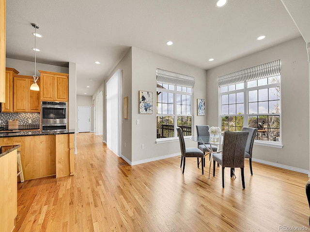 dining room featuring recessed lighting, baseboards, and light wood-type flooring