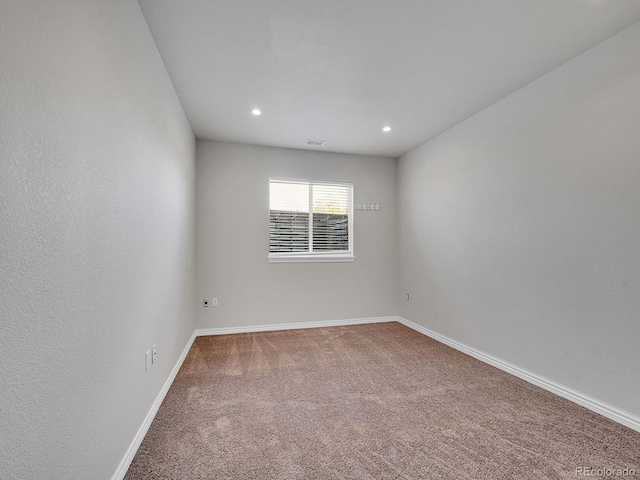 carpeted spare room with baseboards, recessed lighting, and visible vents