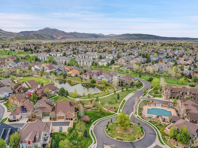 drone / aerial view with a residential view and a water and mountain view