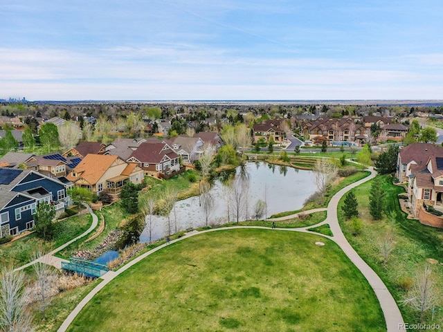 birds eye view of property featuring a water view and a residential view