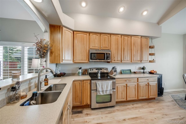 16839 Trail View Cir, Parker, CO 80134 - kitchen with stainless steel appliances, a sink, light countertops, light wood finished floors, and recessed lighting