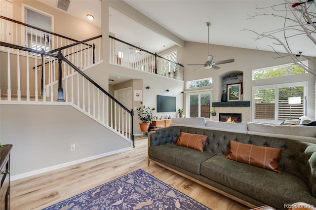 16839 Trail View Cir, Parker, CO 80134 - living area featuring high vaulted ceiling, baseboards, a ceiling fan, wood finished floors, and stairs