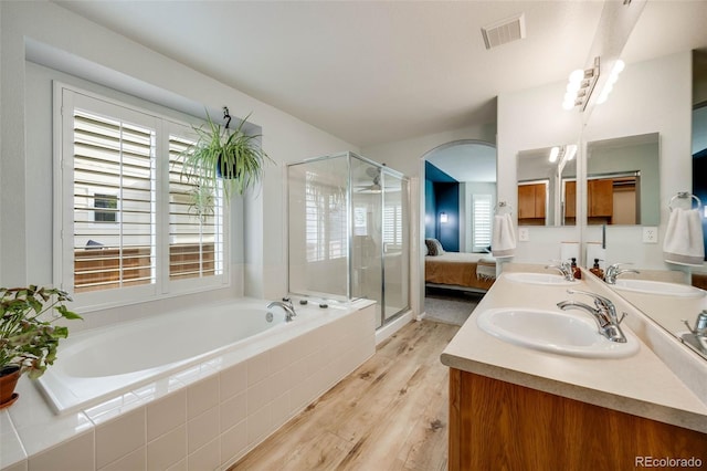 16839 Trail View Cir, Parker, CO 80134 - ensuite bathroom featuring a garden tub, healthy amount of natural light, wood finished floors, and a stall shower