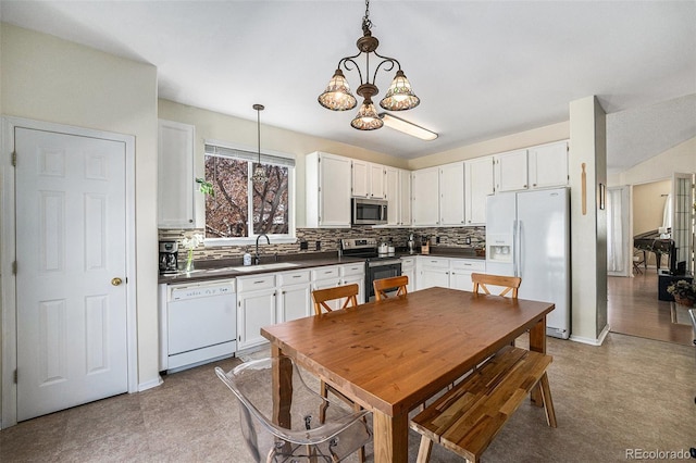 20137 E Prentice Pl, Centennial, CO 80015 - kitchen with decorative backsplash, dark countertops, a sink, a notable chandelier, and stainless steel appliances