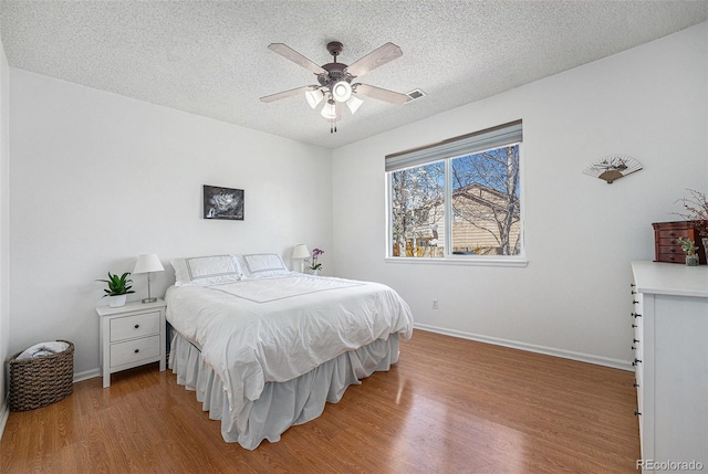 20137 E Prentice Pl, Centennial, CO 80015 - bedroom with baseboards, a textured ceiling, and wood finished floors