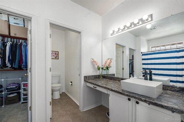 20137 E Prentice Pl, Centennial, CO 80015 - bathroom with vanity, toilet, baseboards, a spacious closet, and visible vents