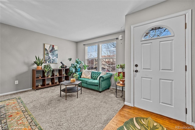 entryway featuring baseboards and wood finished floors