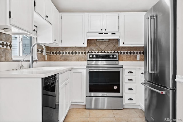 kitchen with light tile patterned floors, white cabinetry, and appliances with stainless steel finishes