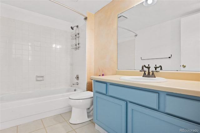 full bathroom with tile patterned floors, toilet, vanity, and tiled shower / bath combo