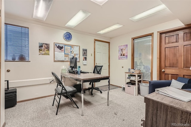 office with crown molding and light carpet