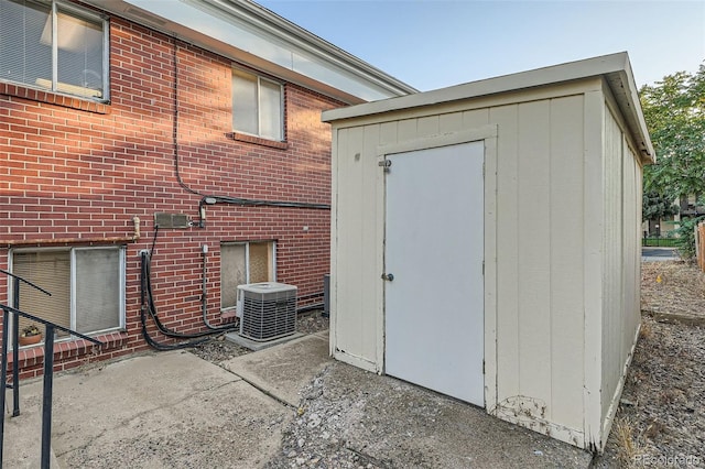 exterior space featuring cooling unit and a storage shed