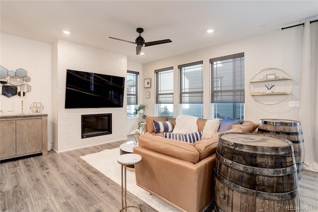 431 Courtfield Way, Castle Pines, CO 80108 - living room with light wood-style flooring, a large fireplace, ceiling fan, and recessed lighting