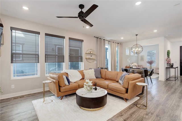 431 Courtfield Way, Castle Pines, CO 80108 - living area with wood finished floors, a chandelier, recessed lighting, and a ceiling fan