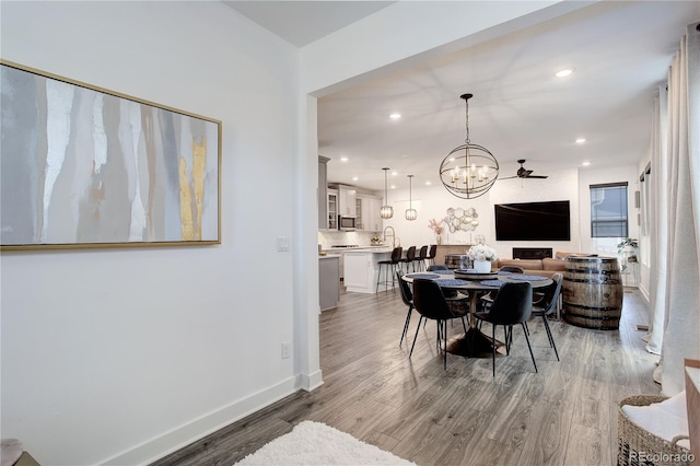 431 Courtfield Way, Castle Pines, CO 80108 - dining room featuring a chandelier, light wood-style flooring, and recessed lighting