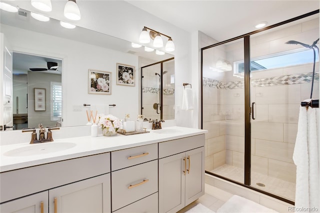 431 Courtfield Way, Castle Pines, CO 80108 - full bath featuring healthy amount of natural light, double vanity, a shower stall, a ceiling fan, and recessed lighting