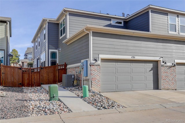 431 Courtfield Way, Castle Pines, CO 80108 - view of property exterior featuring brick siding, a garage, and driveway