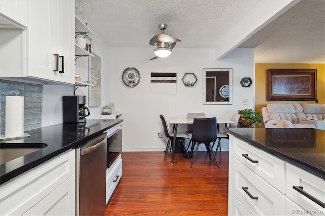 kitchen featuring open shelves, dishwasher, a textured ceiling, dark wood finished floors, and decorative backsplash