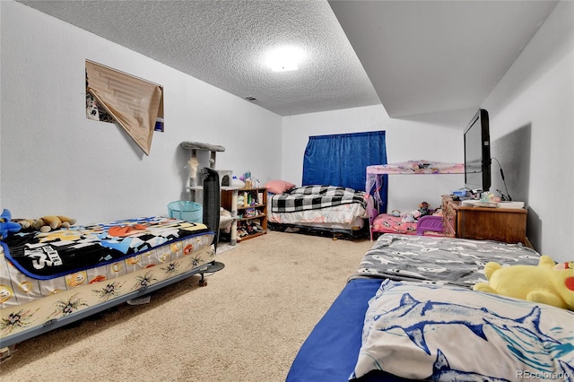 carpeted bedroom featuring a textured ceiling and visible vents