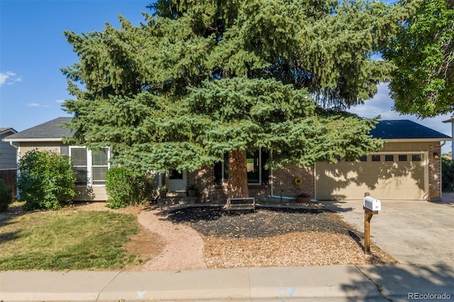 1246 S Telluride St, Aurora, CO 80017 - obstructed view of property with concrete driveway, an attached garage, and brick siding