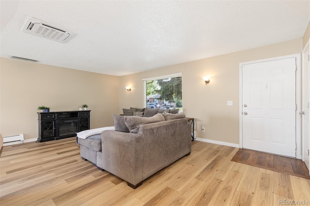 1246 S Telluride St, Aurora, CO 80017 - living area with light wood-style floors and a textured ceiling