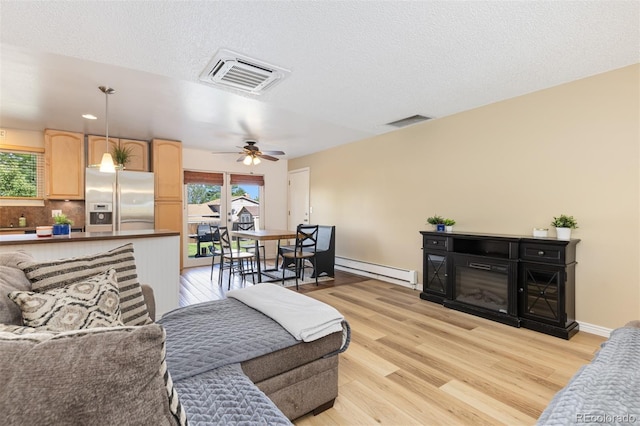 1246 S Telluride St, Aurora, CO 80017 - living room featuring a baseboard heating unit, light wood finished floors, a ceiling fan, a textured ceiling, and recessed lighting