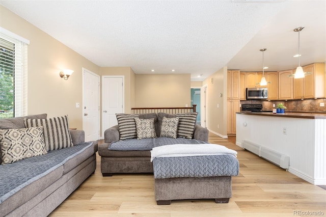 1246 S Telluride St, Aurora, CO 80017 - living area featuring light wood finished floors and recessed lighting