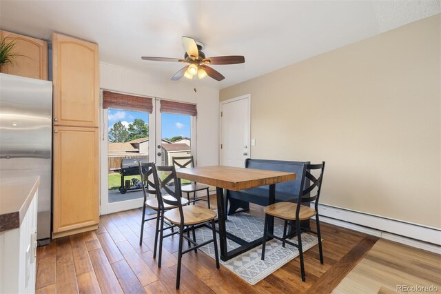 1246 S Telluride St, Aurora, CO 80017 - dining room with ceiling fan, wood finished floors, french doors, and a baseboard radiator