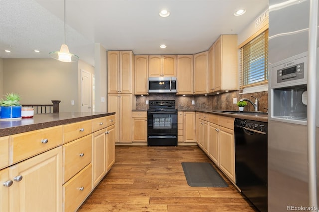 1246 S Telluride St, Aurora, CO 80017 - kitchen with appliances with stainless steel finishes, light brown cabinetry, dark countertops, light wood-style floors, and recessed lighting