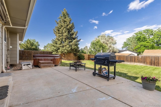 1246 S Telluride St, Aurora, CO 80017 - fenced backyard with a hot tub, area for grilling, and a patio