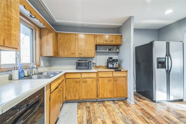 kitchen with dishwasher, stainless steel fridge, light hardwood / wood-style floors, and sink