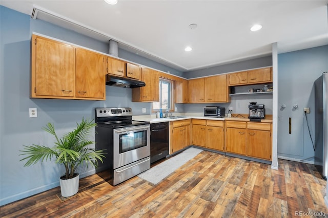 kitchen with stainless steel appliances, light hardwood / wood-style flooring, and sink