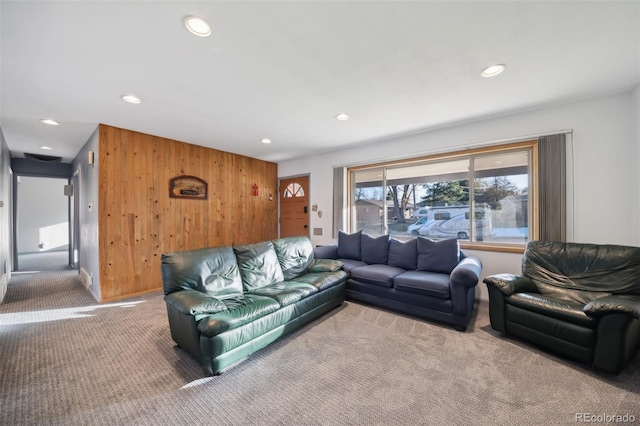 living room featuring carpet and wooden walls