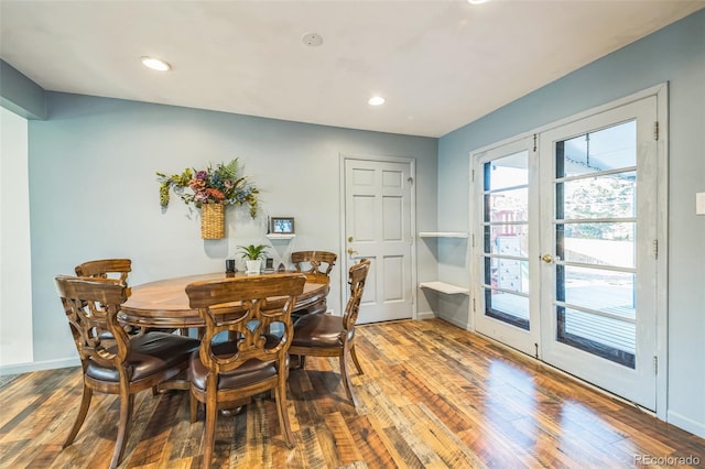 dining area with hardwood / wood-style floors and french doors