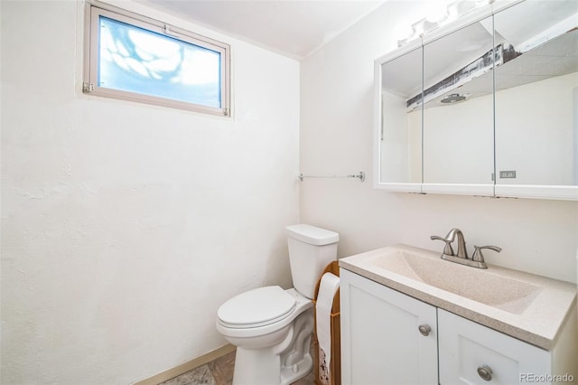 bathroom featuring hardwood / wood-style floors, vanity, and toilet