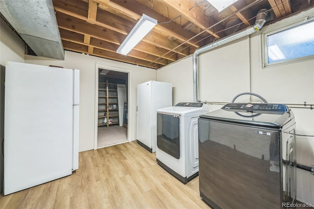 washroom with washer and dryer and light hardwood / wood-style floors