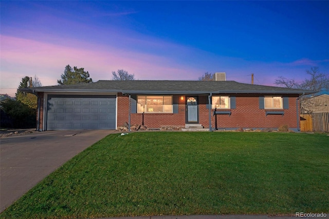 ranch-style house with a yard and a garage