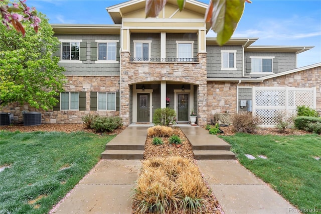 11364 Xavier Dr Unit 205, Westminster, CO 80031 - view of front of home with central air condition unit, a front yard, stone siding, and fence