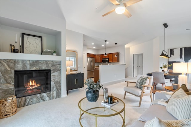 11364 Xavier Dr Unit 205, Westminster, CO 80031 - living area featuring a ceiling fan, visible vents, a tile fireplace, baseboards, and light carpet