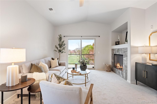 11364 Xavier Dr Unit 205, Westminster, CO 80031 - carpeted living area featuring baseboards, visible vents, lofted ceiling, and a high end fireplace