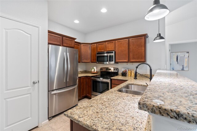11364 Xavier Dr Unit 205, Westminster, CO 80031 - kitchen featuring light stone counters, a sink, stainless steel appliances, recessed lighting, and a peninsula