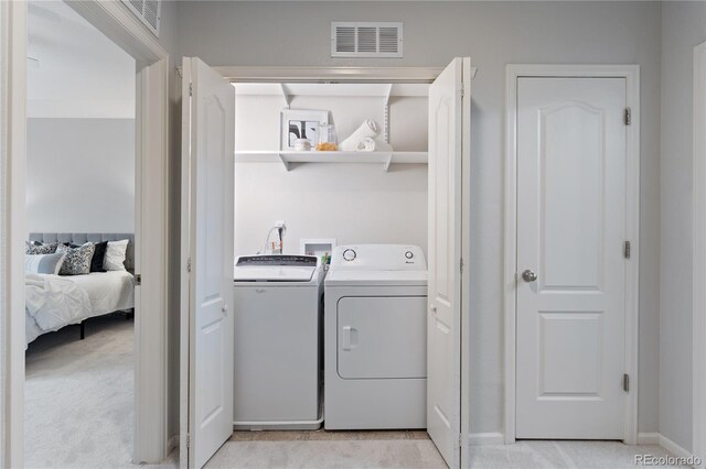 11364 Xavier Dr Unit 205, Westminster, CO 80031 - washroom featuring independent washer and dryer, laundry area, light carpet, baseboards, and visible vents