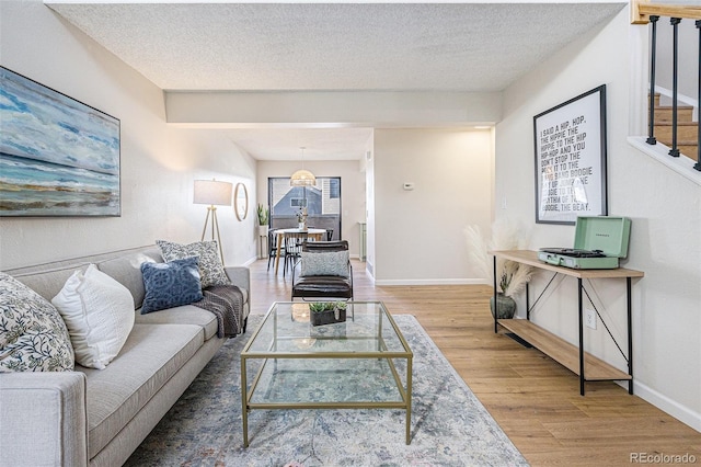 living room with hardwood / wood-style floors and a textured ceiling