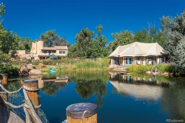 view of dock featuring a water view and a gazebo