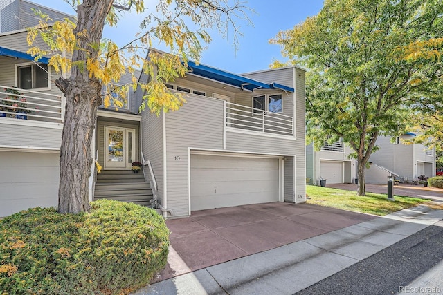 view of front of house featuring a garage and a balcony