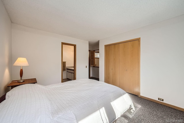 bedroom featuring a closet, a textured ceiling, carpet, and baseboards