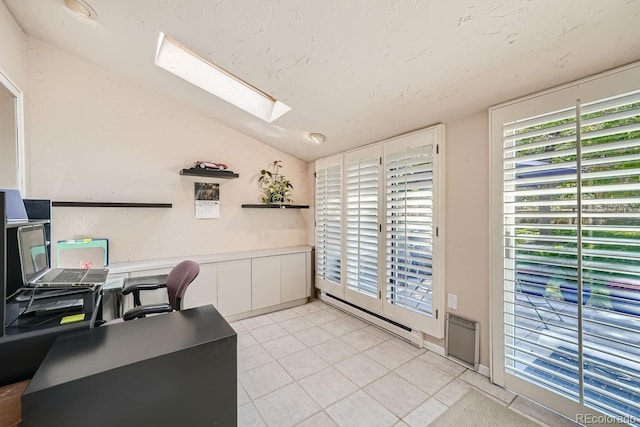 home office featuring light tile patterned floors, baseboard heating, lofted ceiling with skylight, and a textured ceiling