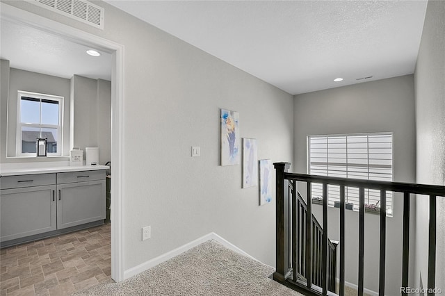 hallway with a textured ceiling