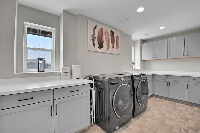 laundry area featuring cabinets and independent washer and dryer