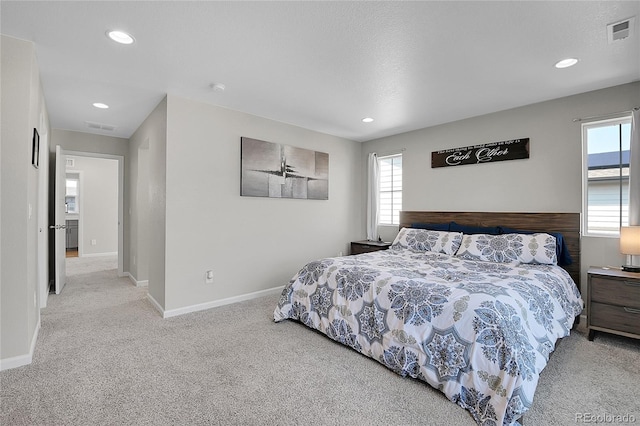 bedroom featuring light colored carpet